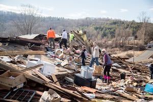 Volunteers begin sorting through the wreckage of a building leveled by a tornado in Conway on Feb. 25. Photo courtesy of Adam Caron Volunteers sort through wreckage of home in Conway after tornado