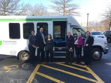 Officials in front of Acton transit bus