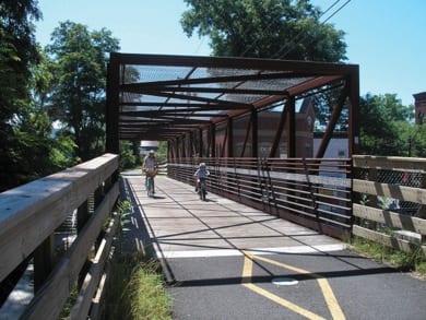 bikers traverse a bridge