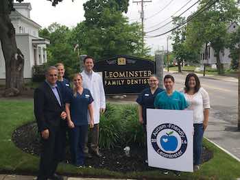 Mayor Mozzarella and Project organizer Stephanie Madrigal gather with staff of Leominster Family Dental