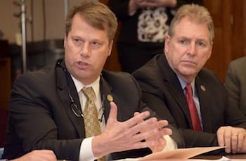 Northampton Mayor David Narkewicz (left) speaks to administration officials about state budget concerns. Listening is Marlborough Mayor Arthur Vigeant.