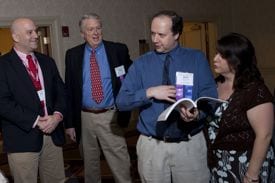 Local officials peruse winning town reports during the MMAâs 2009 Annual Meeting.