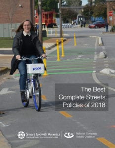 Woman rides bike in a well marked and separated bike lane.
