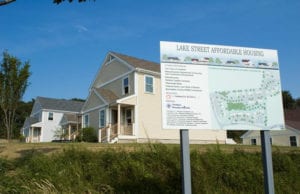 A sign depicting a map is posted in front of a new housing development