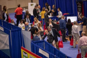 a group of people on the floor of a trade show