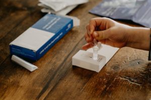 an at home covid test box and components laid out on a table