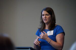 Meredith Harris, executive director of the Marlborough Economic Development Corporation, stands at a podium giving a speech